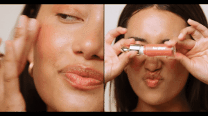 Split-screen portrait of a woman applying peach liquid blush with a glossy finish, photographed by Claire Leahy.