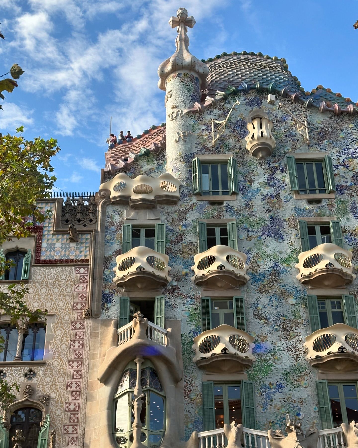 Exterior of Casa Batlló in Barcelona, Spain showcasing the unique architectural details, colorful mosaic facade, and distinctive window design.