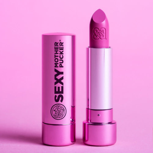 Two pink lipstick tubes by Soap & Glory sit in front of a pink background in a beauty product shot with bright, even lighting.