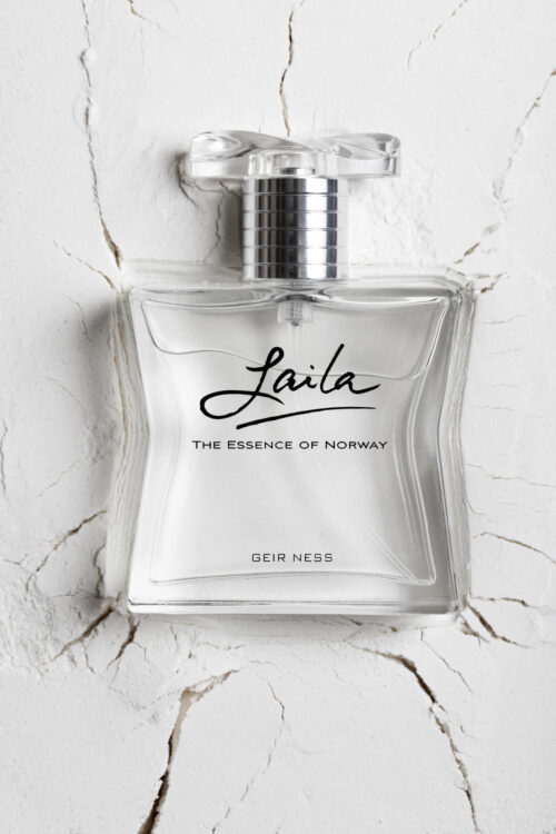 Elegant crystal perfume bottle of Laila, The Essence of Norway, sits on a textured white surface, shot with soft lighting and clarity.