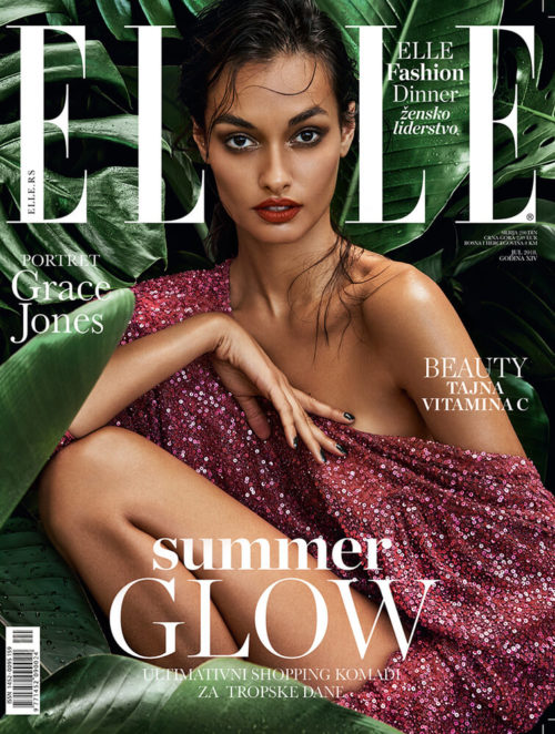 Elle Serbia magazine cover featuring a woman in a sequined dress, surrounded by tropical leaves, promoting fashion and beauty.
