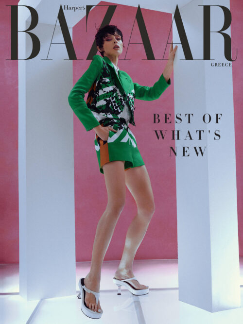 Fashion editorial cover featuring woman in patterned jacket and shorts, striking pose against pink and white backdrop with Bazaar logo.