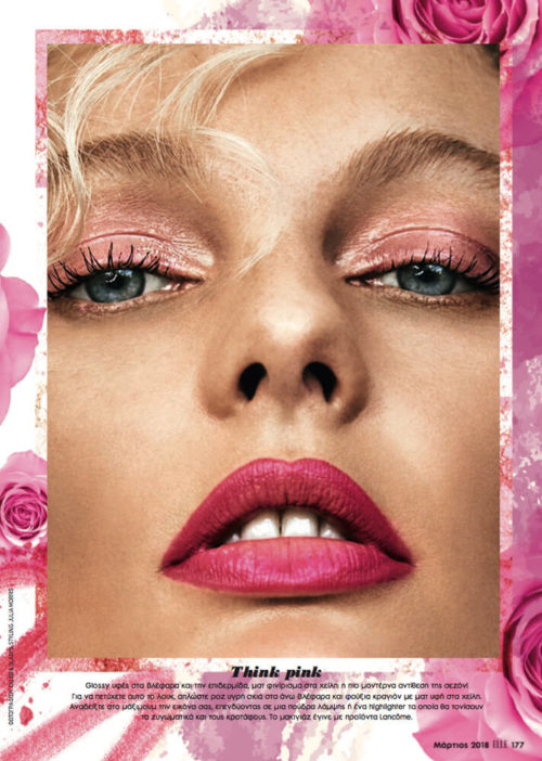Close-up of a woman with pink eyeshadow and lipstick in beauty ad surrounded by pink flowers. Cosmetics and floral elements.