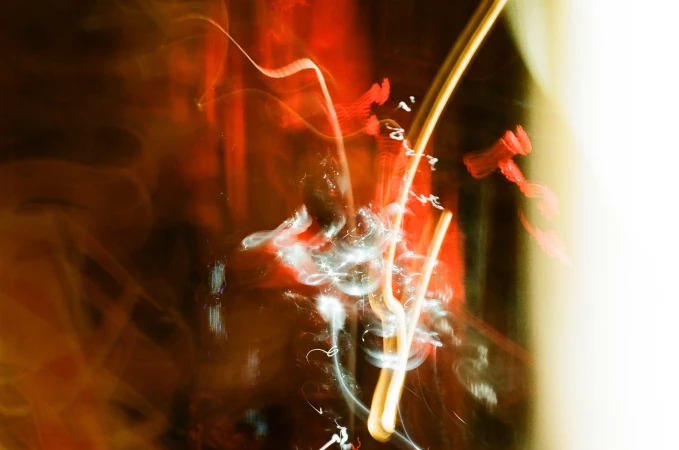 Abstract photo of blurred lights with orange, red, and yellow hues, creating a dynamic and vibrant visual effect, showcasing long exposure.