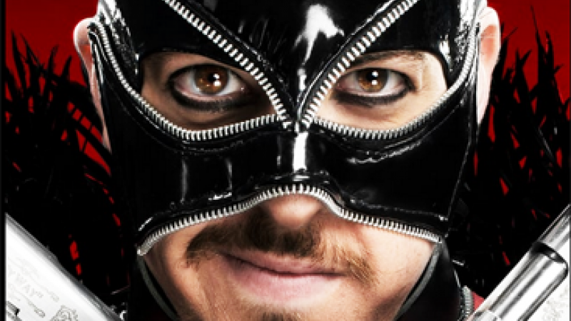 Close-up of a male adult wearing a black zipper mask, facial hair, and holding silver handguns against a red and black background.
