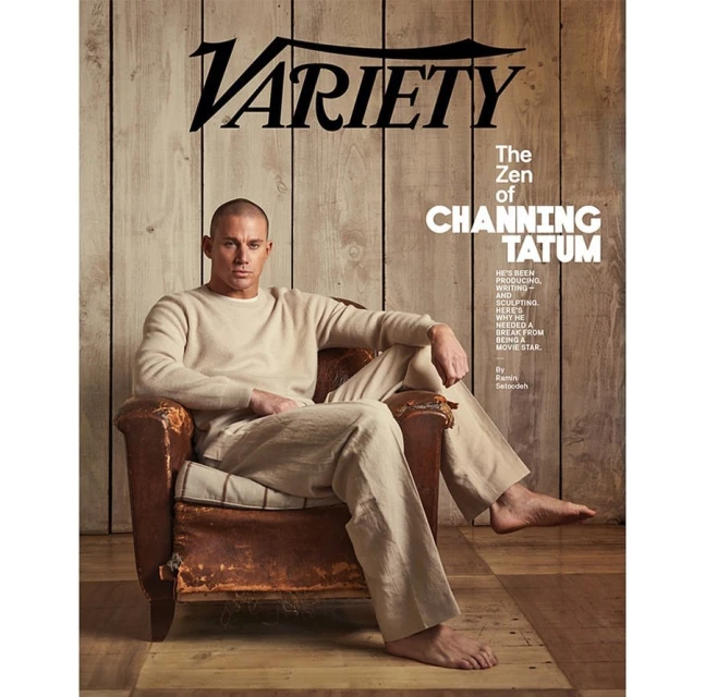 Channing Tatum lounges barefoot in an armchair on a Variety magazine cover, in a light-filled studio with a rustic wood backdrop.