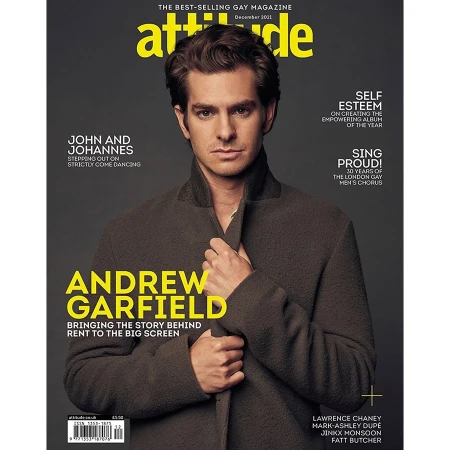 Andrew Garfield on the cover of Attitude magazine, December 2021. He's in a dark jacket with yellow text overlay on a grey backdrop.