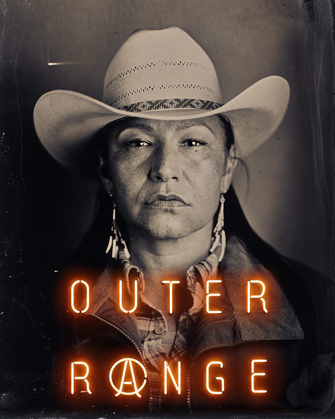 Portrait of an indigenous woman wearing a cowboy hat and beaded earrings, featuring neon signage with the words 'Outer Range'.
