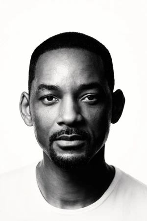 Close-up studio portrait of adult male, Brian Bowen Smith, in black t-shirt with blurred black background and rim lighting.