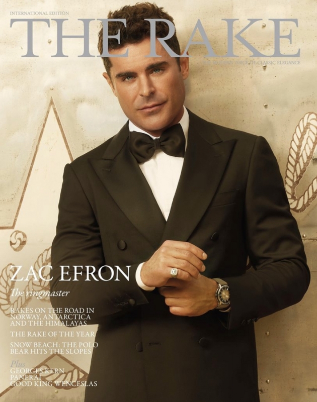 Magazine cover featuring Zac Efron wearing a black tuxedo with a bow tie, posing against a textured background, wearing a ring and watch.