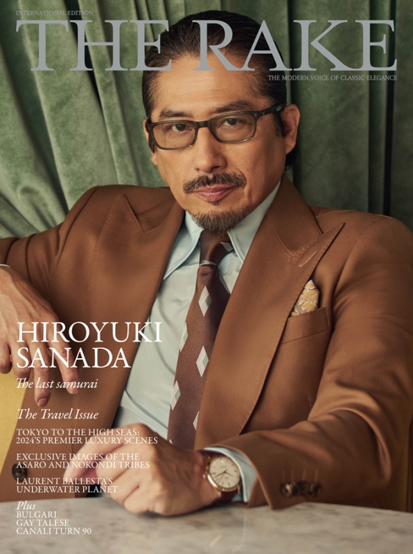 Magazine cover featuring Hiroyuki Sanada wearing a brown suit. The magazine is titled 'The Rake'. Cover also features text about travel and luxury.