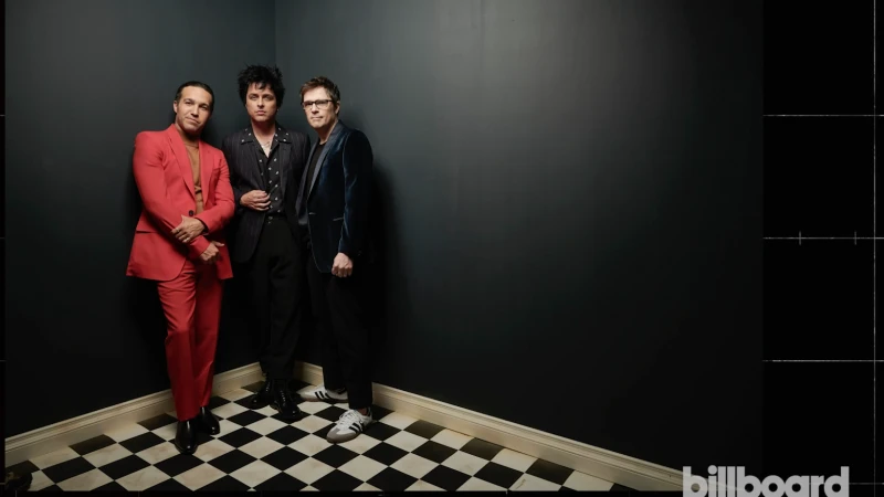 Three band members in formal wear pose indoors against a black wall on a black-and-white checkerboard floor in a portrait shot.