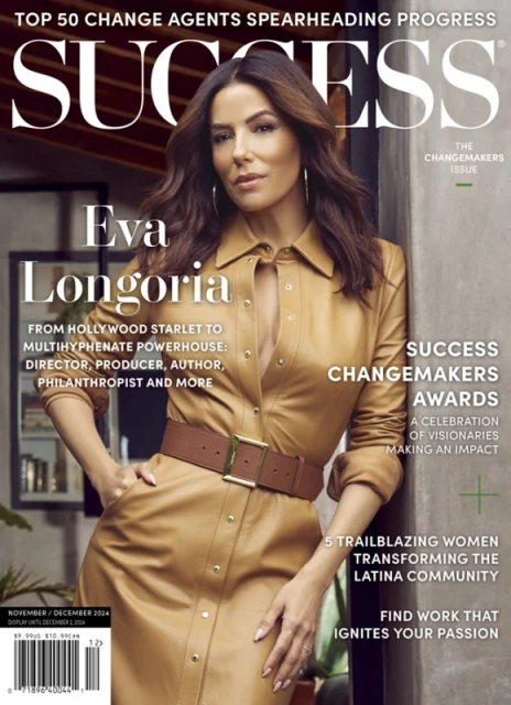 Eva Longoria graces the cover of Success magazine, styled in a tan dress with belt, posing indoors against a soft, neutral backdrop.