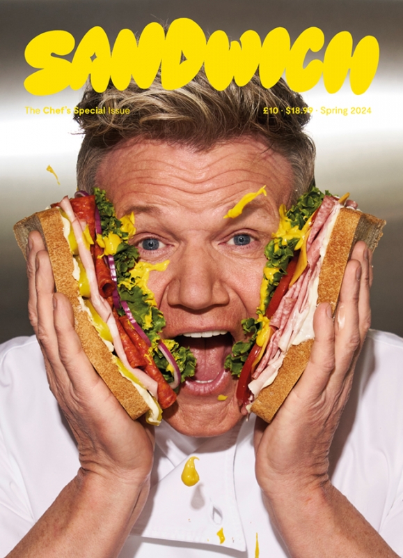 Gordon Ramsay holding halves of a large sandwich against his face, photographed by Brian Bowen Smith