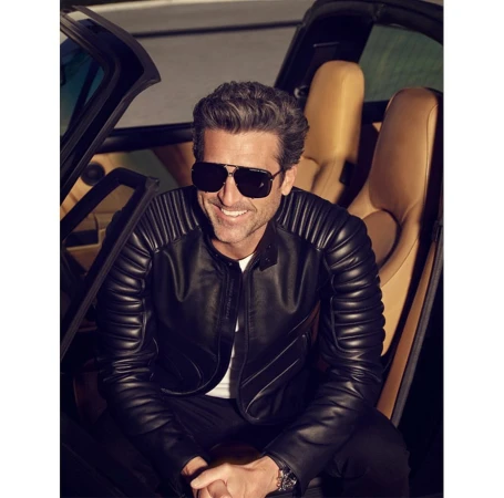 Man wearing sunglasses and a black leather jacket sitting inside a sports car with tan leather seats, photographed by Brian Bowen Smith.