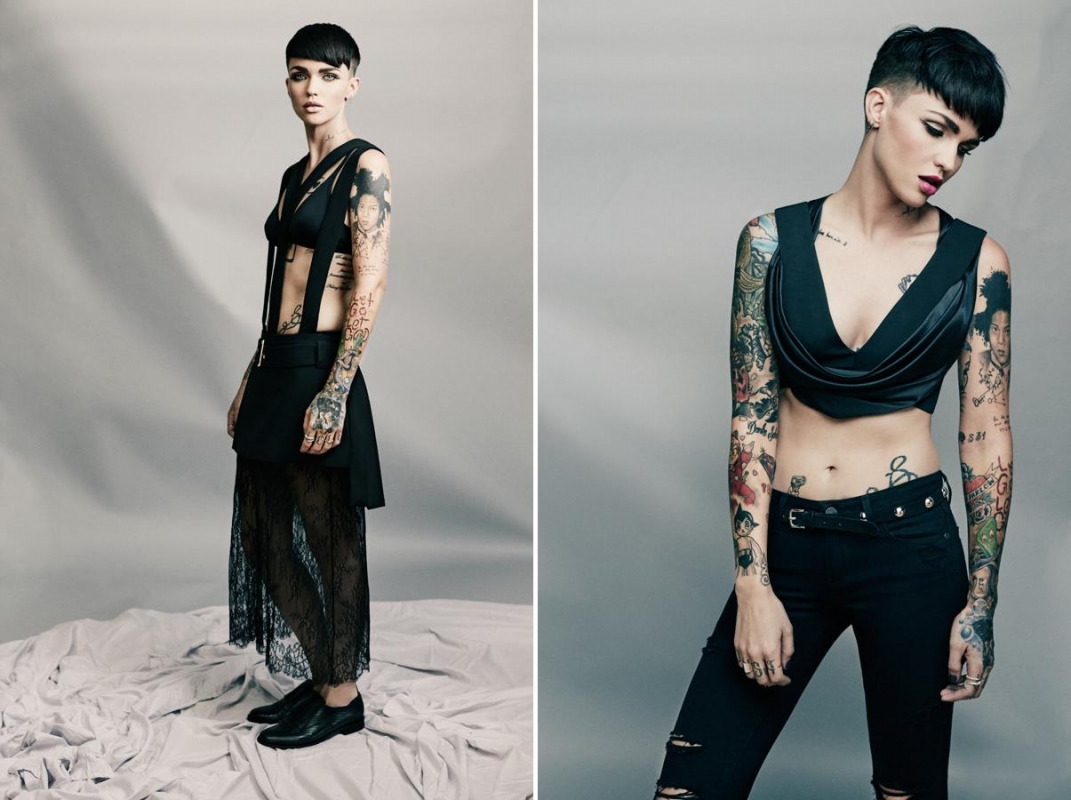 Two shots of Ruby Rose in black apparel, featuring a crop top and skirt, against a plain background, showcasing tattoos and short hair.