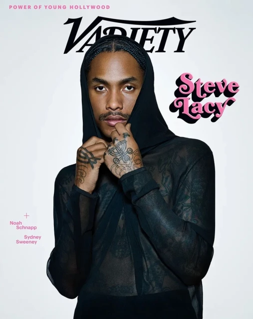 Steve Lacy on Variety magazine cover with a black hooded sheer shirt and tattoos, set against a white background.