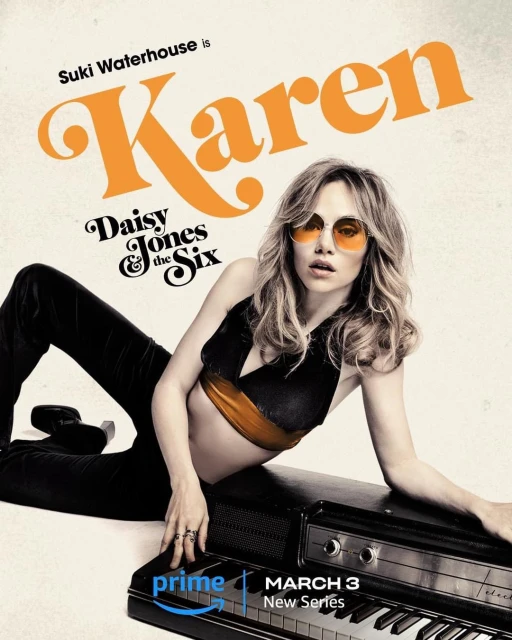 Suki Waterhouse as Karen in Daisy Jones & The Six new series, laying on a piano wearing sunglasses, black top and pants.