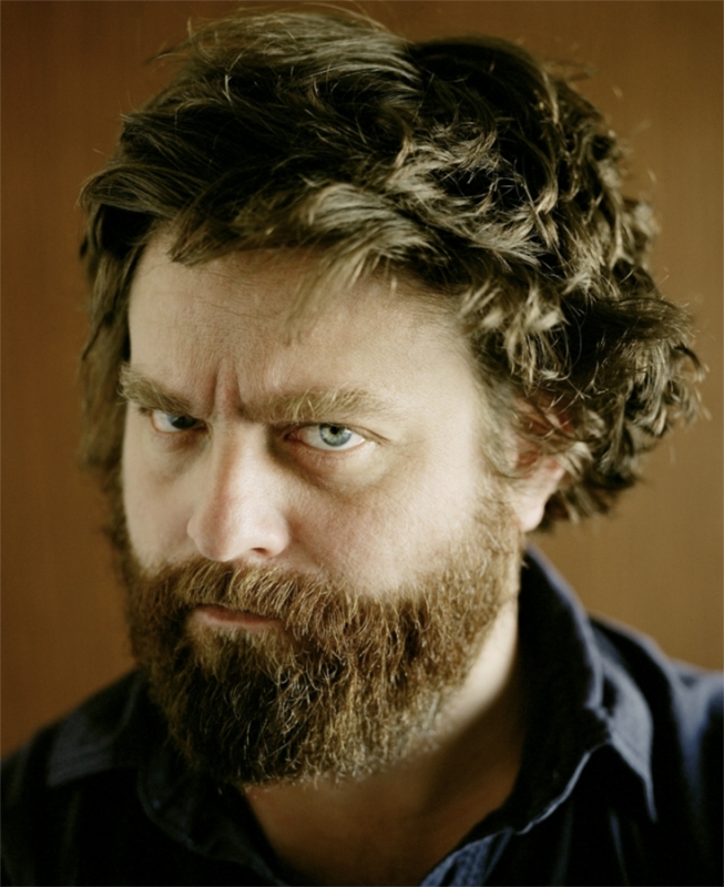 Close-up portrait of comedian Zach Galifianakis with a thick brown beard and dark wavy hair, captured by Pamela Littky.