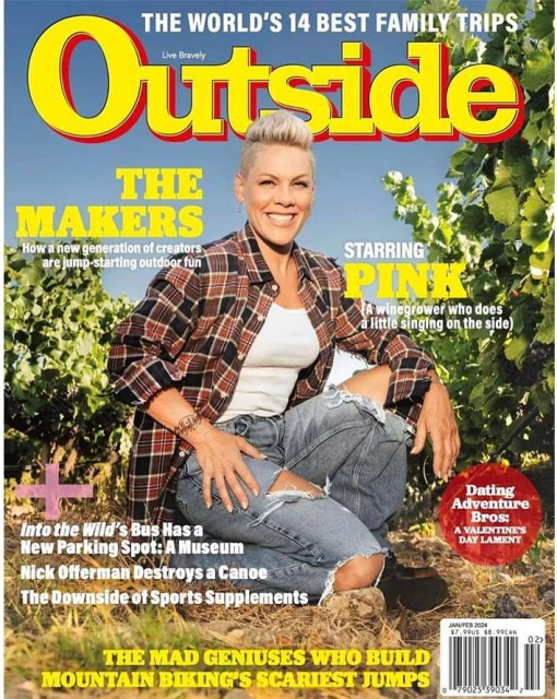 Magazine cover featuring Pink in casual wear, set against a vineyard and blue sky. Cover promotes family trips and mountain biking content.