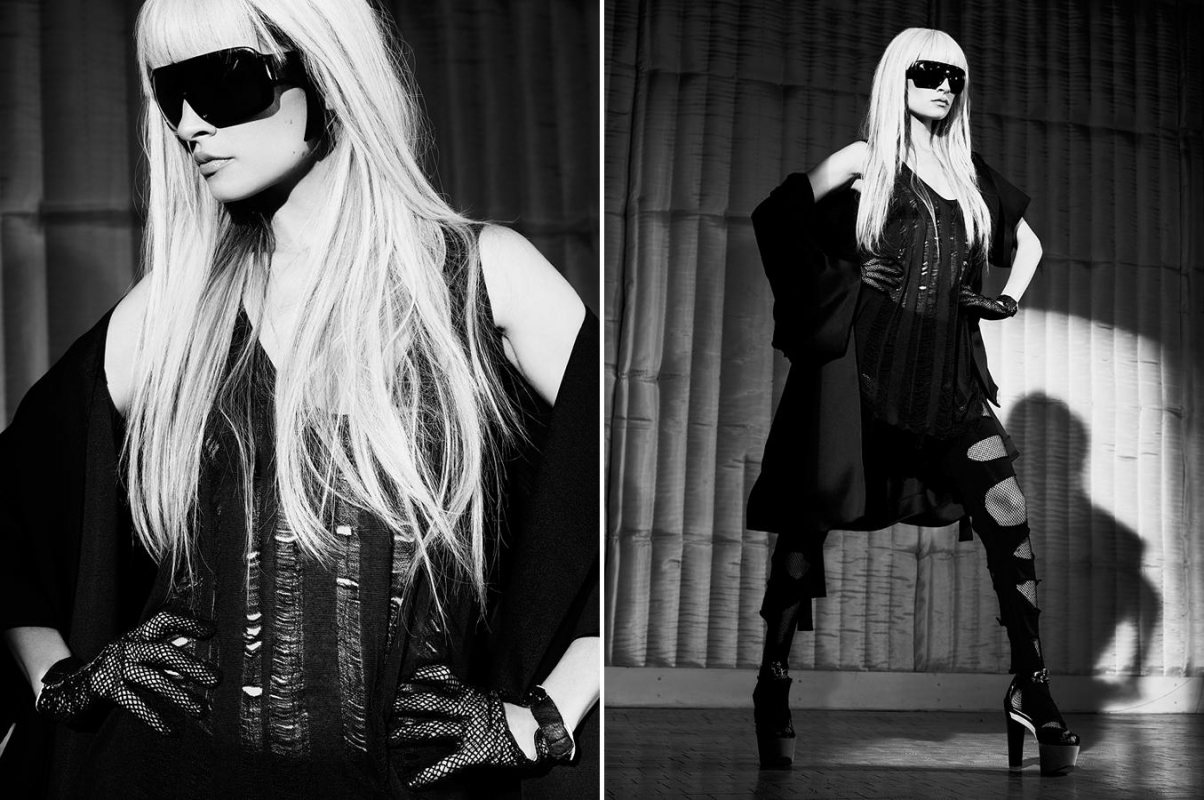 Black and white portrait of a blonde woman wearing oversized sunglasses and a black dress by Andrew Macpherson.