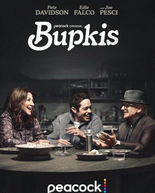 Poster art from the Peacock original television series, Bupkis, featuring Pete Davidson, Edie Falco, and Joe Pesci sitting at a table.