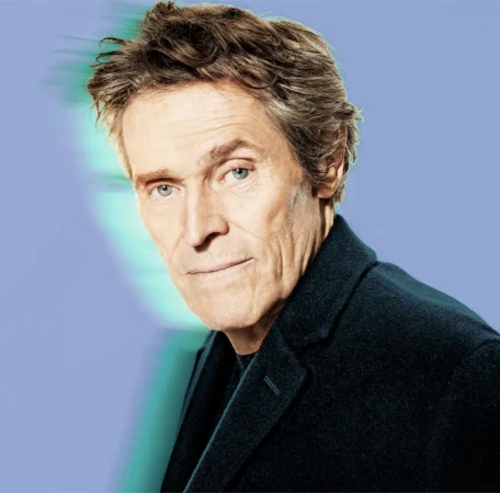 Portrait of Willem Dafoe wearing a dark blazer against a light blue background with a motion blur outline.