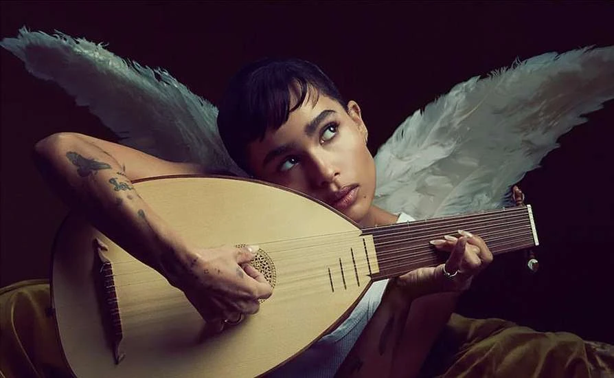 Woman poses with lute and angel wings against dark backdrop, looking up with dreamy expression, artistic, close-up.