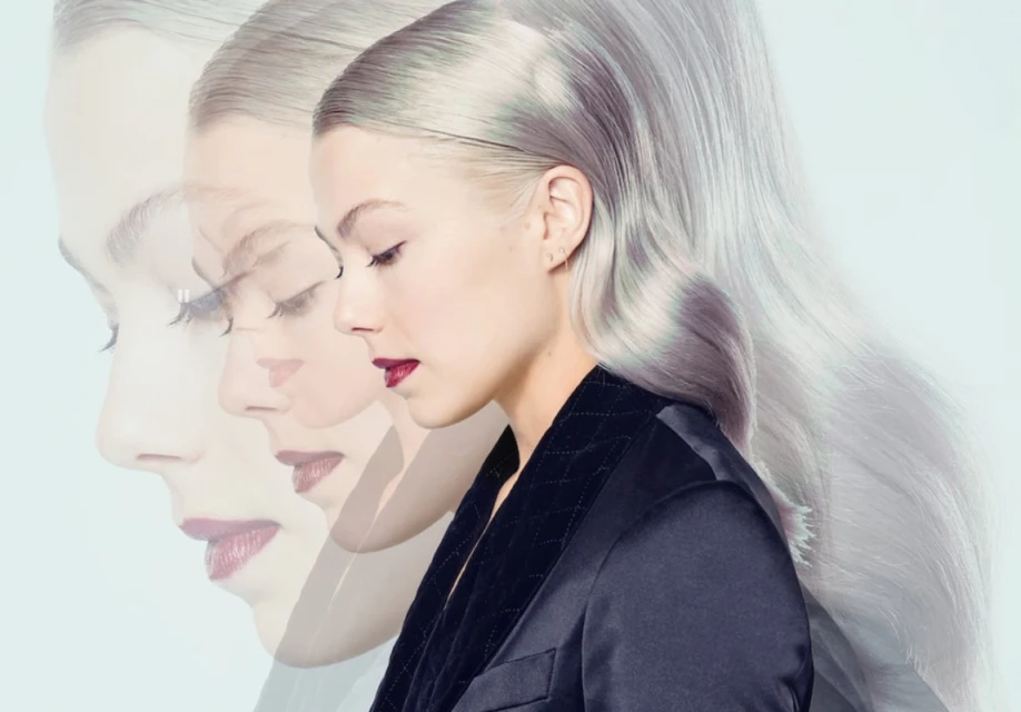Profile portrait of a woman with light hair in a dark jacket, against a light background, with a layered, ethereal effect. Fashion, beauty.