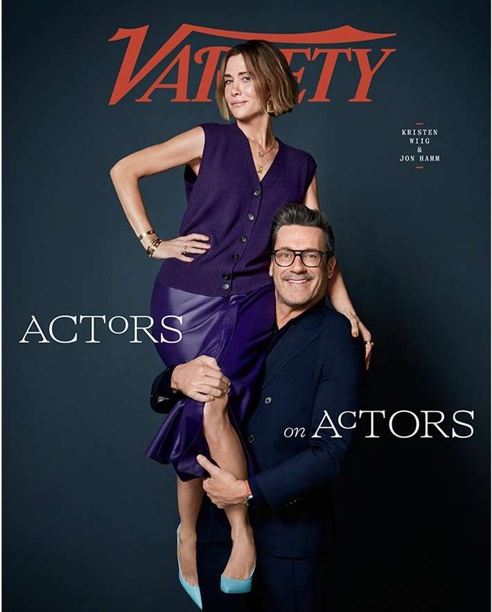 Variety magazine cover featuring Kristen Wiig standing on Jon Hamm's shoulders. Both wear purple attire against a dark backdrop.