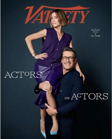 Variety magazine cover featuring Kristen Wiig standing on Jon Hamm's shoulders. Both wear purple attire against a dark backdrop.