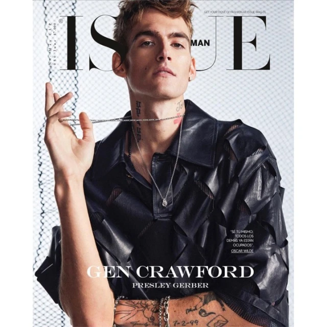 Magazine cover featuring a young male adult with light brown hair in a black leather shirt holding a silver chain necklace.