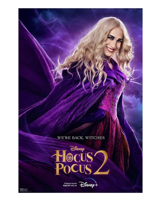 Hocus Pocus 2 movie poster featuring Sarah Jessica Parker with curly blonde hair, purple cape, and red dress against a smoky purple backdrop.