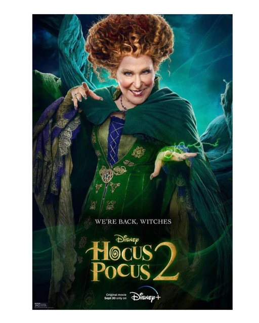 Promotional movie poster for Hocus Pocus 2 with adult female with orange curly hair wearing a green dress and cape.