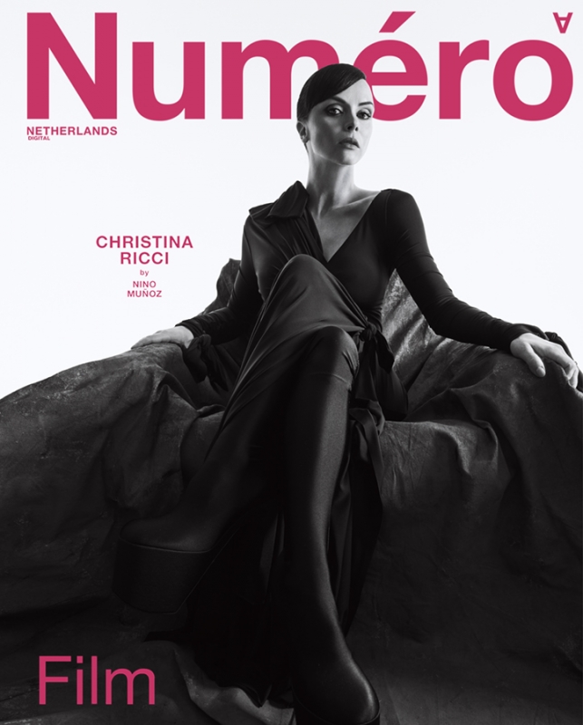 Magazine cover featuring Christina Ricci in a long black dress, seated against a textured gray background with pink 'Numéro' title text.