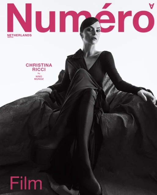 Magazine cover featuring Christina Ricci in a long black dress, seated against a textured gray background with pink 'Numéro' title text.