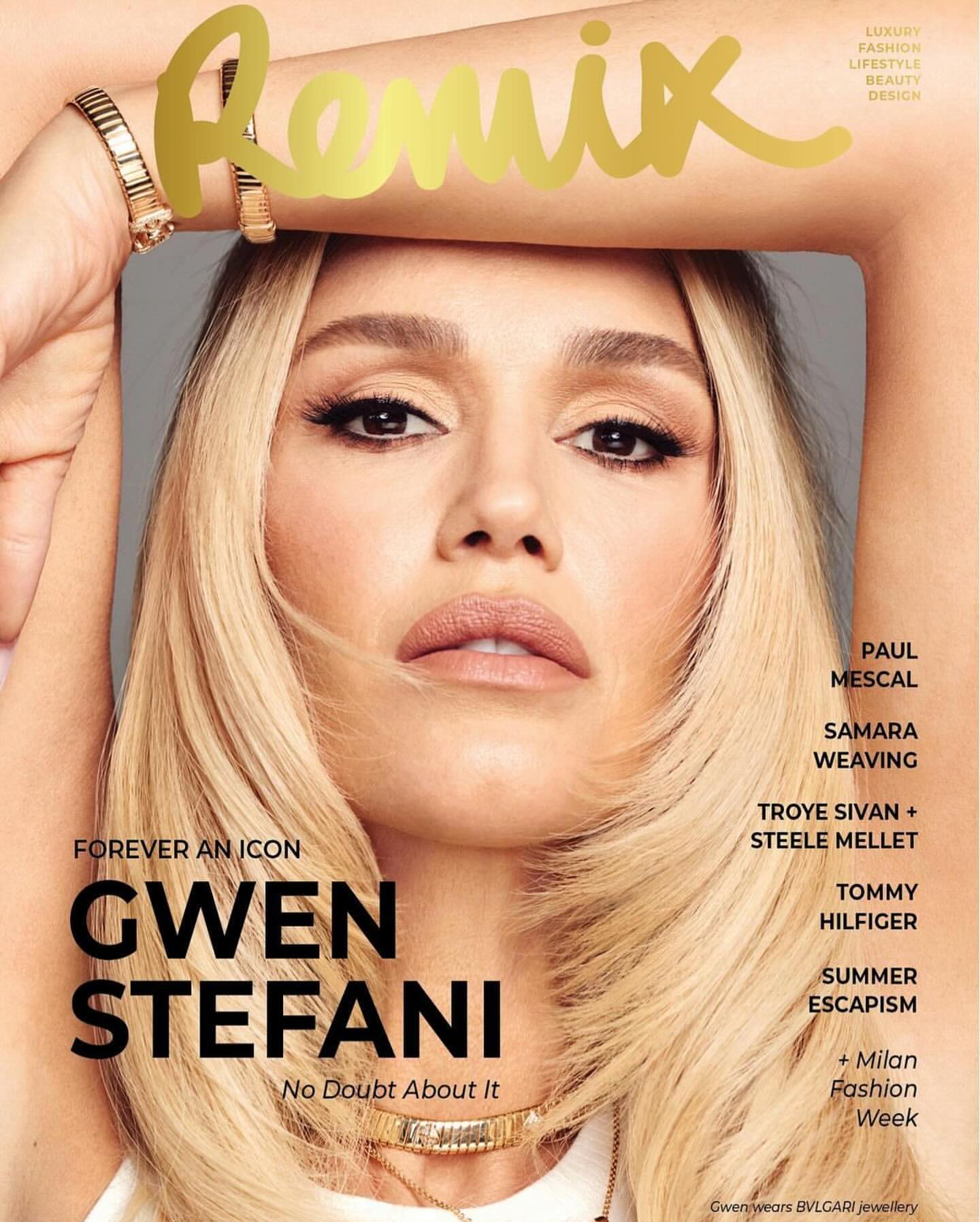 Close-up fashion magazine cover featuring Gwen Stefani with blonde hair, gold jewelry, posing in a light grey indoor setting.