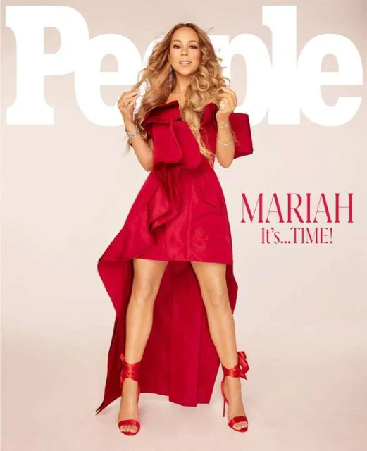 Mariah Carey poses on People magazine cover wearing red dress and heels. Light-skinned woman with blonde wavy hair in a studio setting.