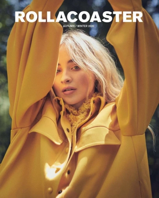 Portrait of a blonde woman wearing a mustard-yellow jacket with a lace top for the cover of Rollacoaster Magazine Autumn/Winter 2020.