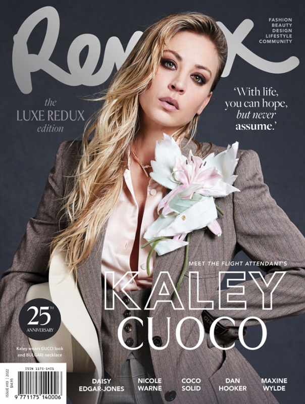 Magazine cover featuring Kaley Cuoco wearing a gray suit with a large white flower, promoting fashion, beauty, and lifestyle.