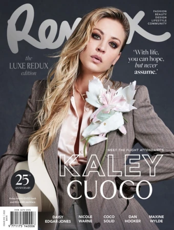 Magazine cover featuring Kaley Cuoco wearing a gray suit with a large white flower, promoting fashion, beauty, and lifestyle.