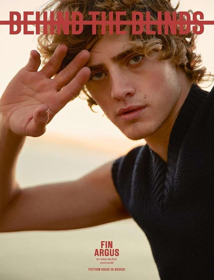 Magazine cover featuring a young adult with curly hair, a dark sleeveless shirt, and soft diffused light suggesting an outdoor location.
