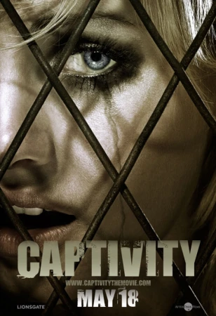 Close-up of a distressed adult female with tears, partially obscured by metal bars. Image promotes the film 'Captivity'.