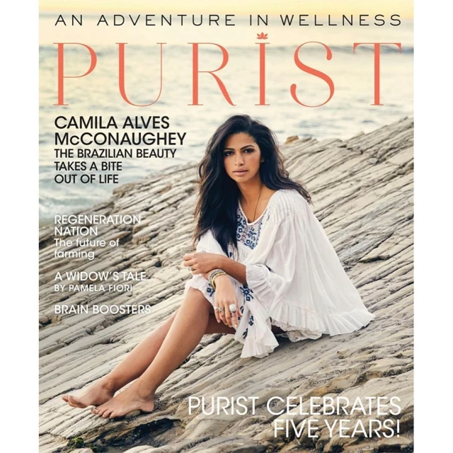 Magazine cover featuring Camila Alves McConaughey sitting on rocks near the ocean at sunset, promoting wellness and celebrating five years.