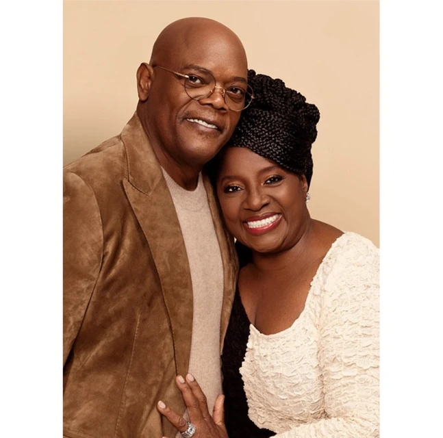 A smiling Samuel L. Jackson and LaTanya Richardson Jackson pose together in a medium shot, showcasing their elegant attire and warm expressions.