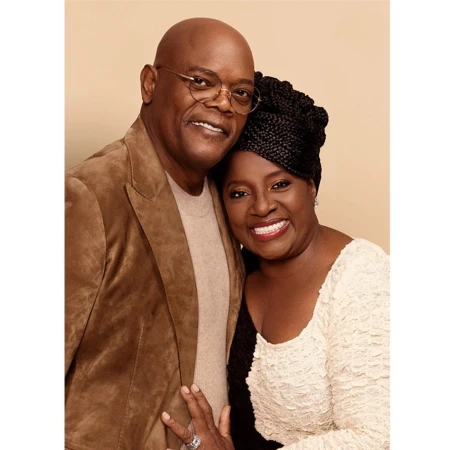 A smiling Samuel L. Jackson and LaTanya Richardson Jackson pose together in a medium shot, showcasing their elegant attire and warm expressions.