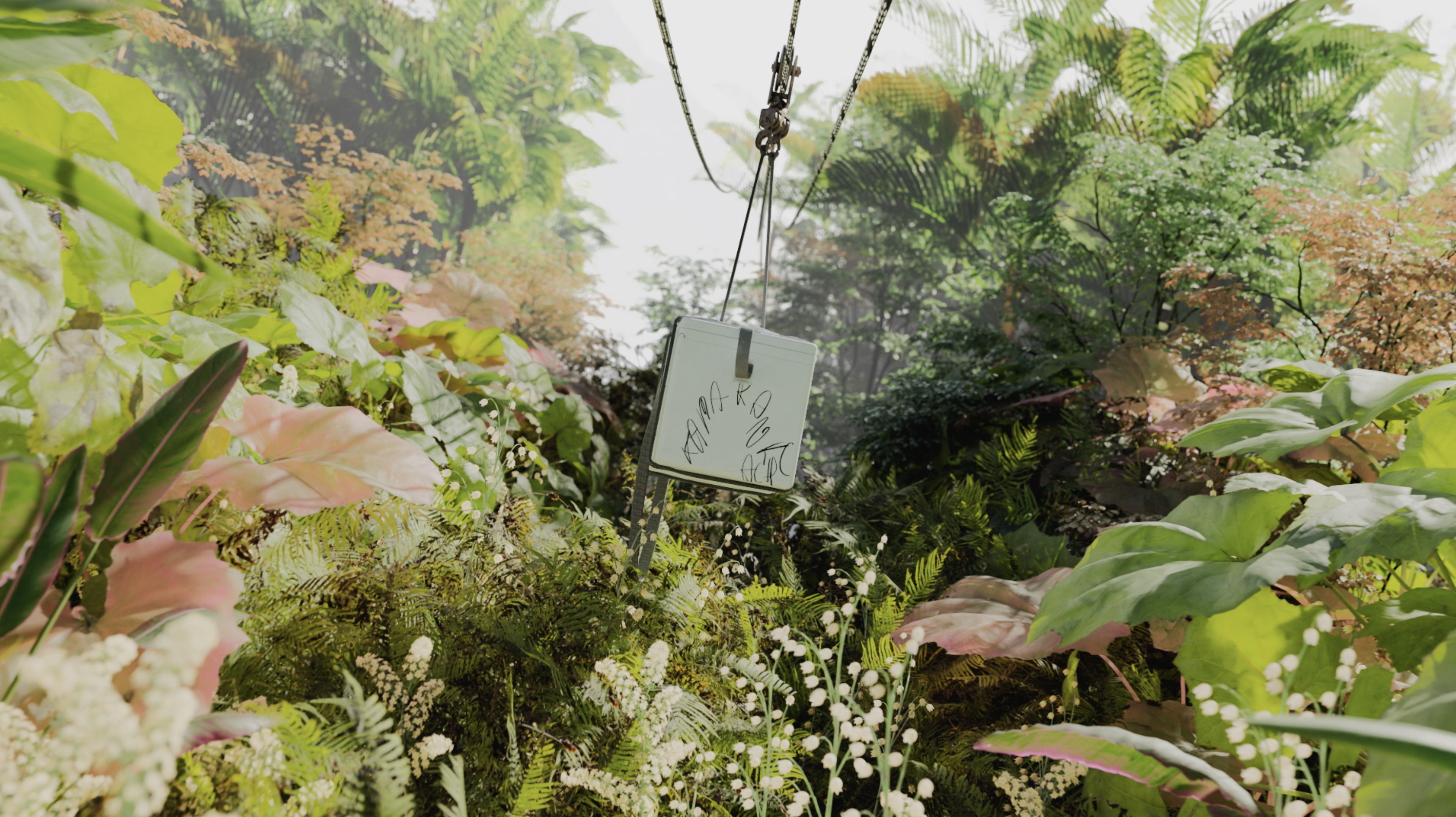 Jungle scene featuring a white object hanging from ropes amidst lush greenery, dense foliage, and diverse plant life in a natural setting.