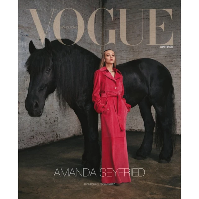Vogue cover featuring Amanda Seyfried posing beside a black horse against a brick wall background in a photo studio, June 2023.