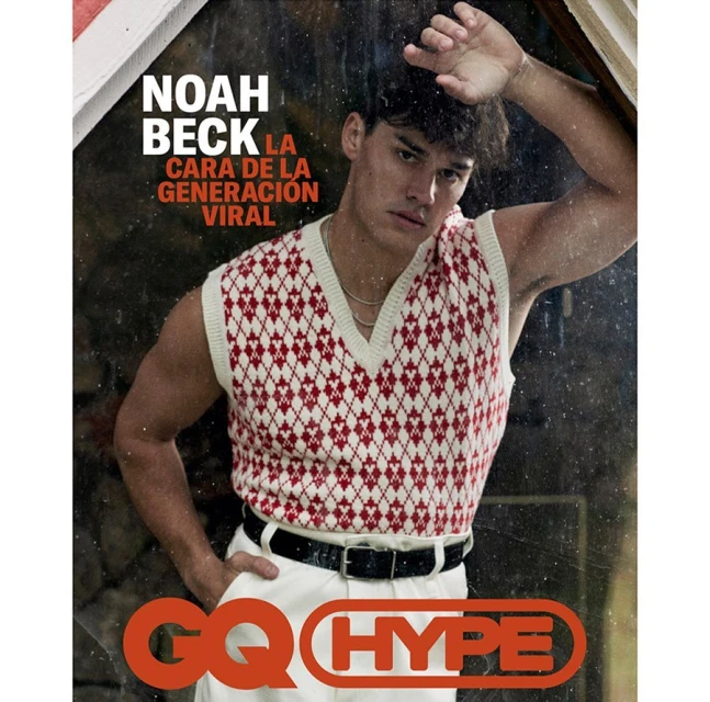 Magazine cover featuring Noah Beck in a patterned sweater vest, posing indoors with a serious expression and hand on his head.