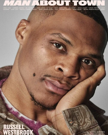 Close-up magazine cover featuring Russell Westbrook in a casual brown jacket with short hair, resting his face on his hand.